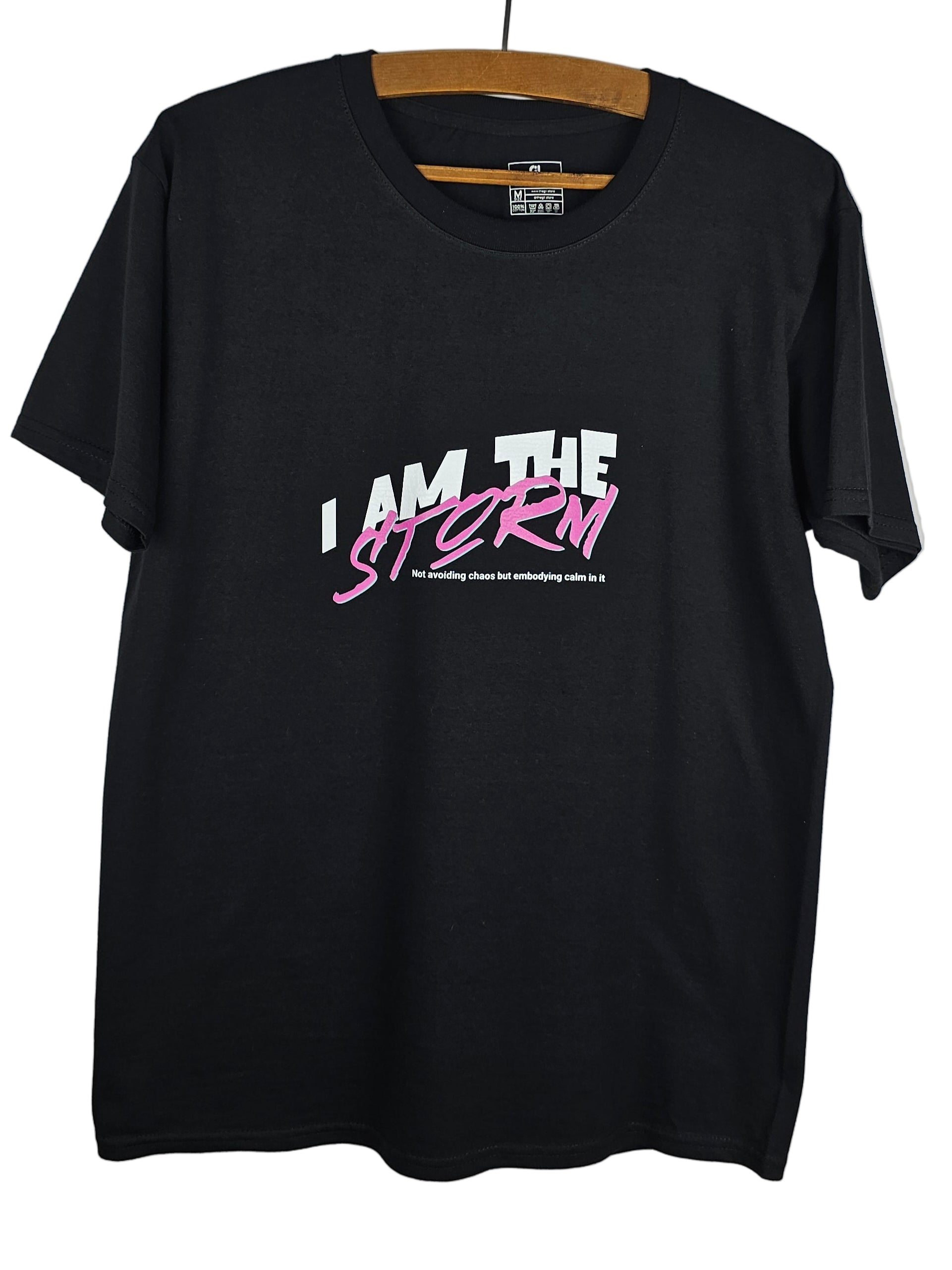 Black t-shirt with 'I AM THE STORM' text in white and pink on a plain background